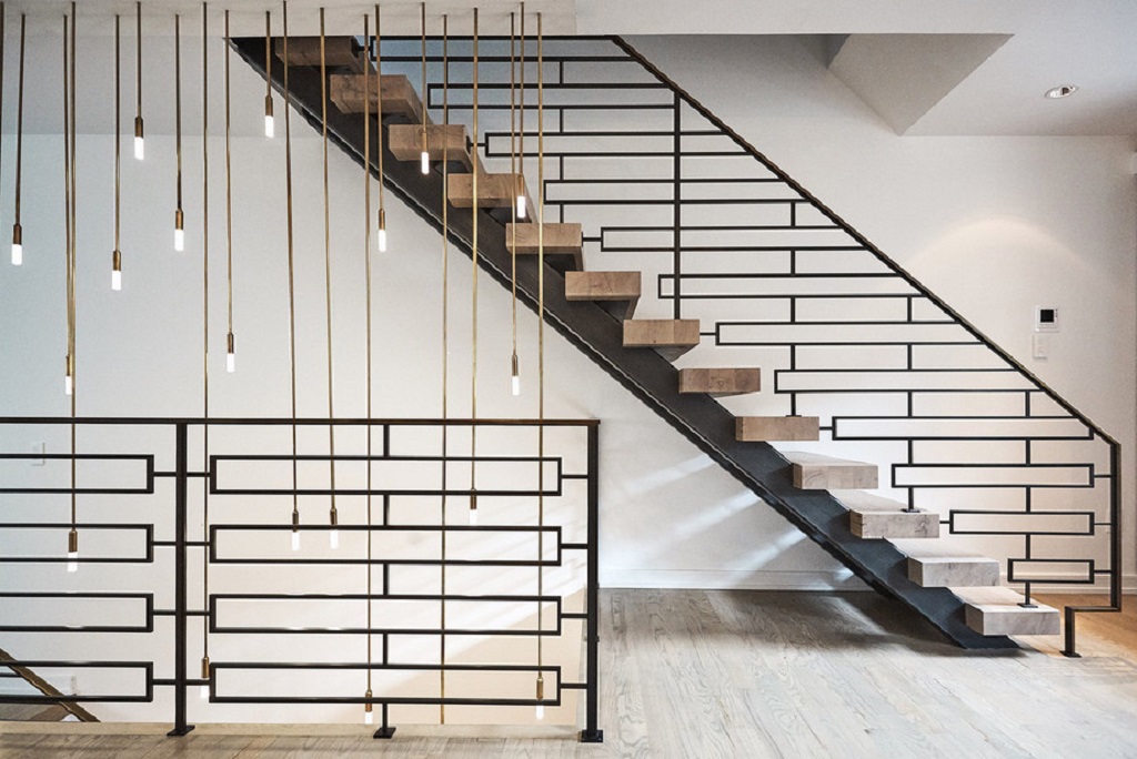 Industrial themed staircase features black mesh railings